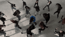 a group of women are dancing in a circle with one wearing a black shirt that says ' i love you ' on it