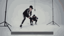 two men are squatting down in front of a white background and one of them says " он больше не наберет " on the bottom