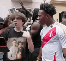 a man in a number 9 jersey stands next to a boy in a black shirt