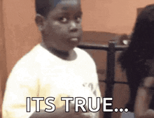 a young boy is making a funny face and says `` it 's true '' .