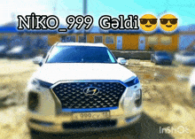 a white car with a license plate that says k999 cv 13