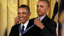 a man in a suit and tie is being awarded a medal