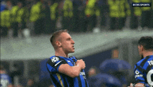 a man in a blue and black jersey with the number 8 on the back