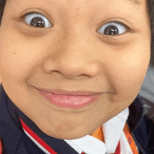 a close up of a child 's face with a silly look on his face