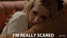 a woman laying on a couch with the words i 'm really scared