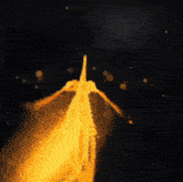 a blurred image of a person 's hand holding something in a dark room .