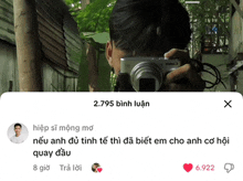 a man is taking a picture with a canon camera and the number 2795 is above him