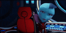 a blue alien is sitting in a red chair with a red cross on the back