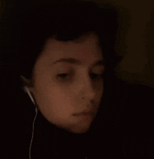 a close up of a woman 's face with headphones on