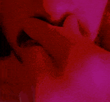 a close up of a man 's mouth with a red background