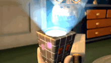 a person is holding a cube in their hand with a light coming out of it