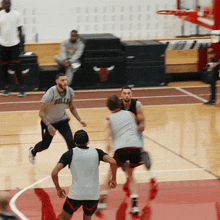 a basketball player wearing a shirt that says bulls dribbles the ball