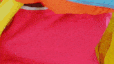 a pink bag with a white zipper has a red object in it