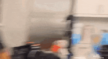 a blurry picture of a person standing next to a refrigerator .