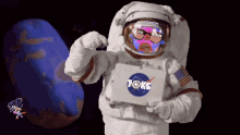 a nasa astronaut holding a box that says toks