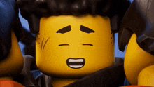 a close up of a lego character with his eyes closed and a smile on his face