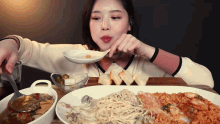 a woman is eating a large plate of food