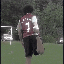 a man wearing a red shirt with the number 7 on the back