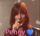 a man singing into a microphone with the name penny written in pink