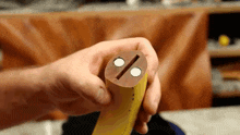a person is holding a piece of wood with two magnets in it