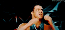 a man with a medal around his neck is blowing his nose .