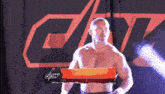 a wrestler is standing in front of a sign that says cpw