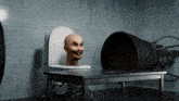 a man 's head is sticking out of a toilet bowl