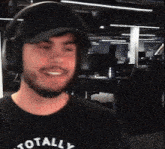 a man wearing headphones and a shirt that says totally on it