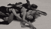 a group of women are laying on the floor hugging each other