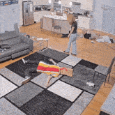a man is laying on the floor in a living room with a sign that says ' i love you ' on it