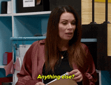 a woman in a red jacket is holding a clipboard and saying anything else