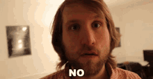 a man with a beard and long hair says no