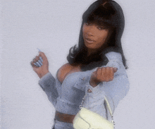 a woman in a denim jacket is holding a white purse and giving the middle finger