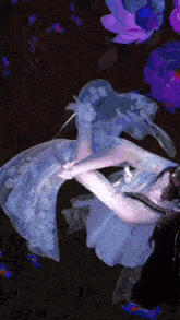 a painting of a woman in a blue dress with purple flowers in the background
