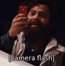 zach galifianakis camera flash taking a pic phone