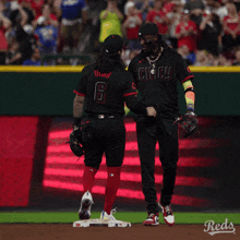 two baseball players one of whom has the number 6 on their jersey