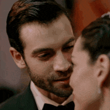 a close up of a man and woman kissing