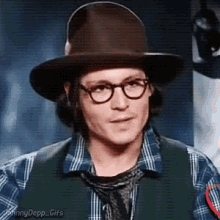 johnny depp is wearing a hat and glasses .