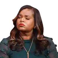 a woman wearing a green sweater and a gold necklace
