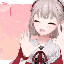 a girl in a red dress is smiling and making a peace sign with her hands
