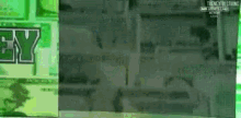 a man is walking in front of a green sign that says ey