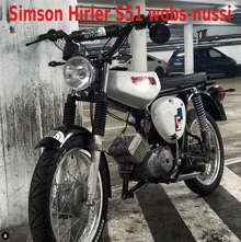 a simson motorcycle is parked in a garage