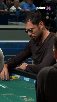 a man sits at a poker table with the words poker go on the bottom