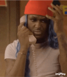 a man wearing a red hat is talking on a telephone with the words well did you see him behind him