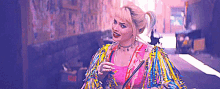a woman in a colorful outfit is walking down a street .