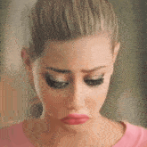 a woman in a pink shirt is making a funny face with her mouth open .