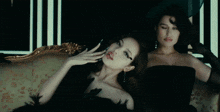 a woman in a black dress holds a black feather
