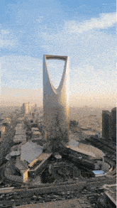 an aerial view of a city with a tall building in the middle