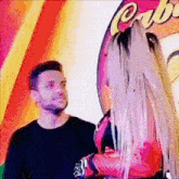 a man and a woman are standing next to each other .
