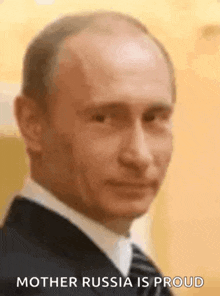 a close up of a man in a suit and tie with the words `` mother russia is proud '' written on the bottom .